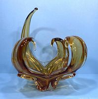 Front view of the vintage amber MCM art glass bowl showing its flowing curved forms and clear tips.
