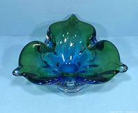 Top-down view showing the green and blue coloration and the organic form of the glass bowl