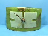 Front angled view of the green Murano glass clock showing the curved rectangular shape and the clock face with gold-tone hands and Albatros Murano signature.