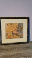 Full view of the framed vintage tapestry depicting a peacock bird with flowers and bamboo.
