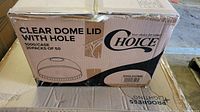 Closed cardboard box labeled "Choice Clear Dome Lid with Hole 1000/Case 20 Packs of 50" showing the product brand and details.
