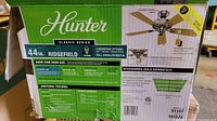 Box with product details showing Hunter Ridgefield Classic Series 44 inch ceiling fan specifications and features.