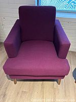 Single purple chair front view showing cushion and leg detail