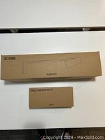 Two cardboard boxes on white surface, one labeled SCRIBE and one labeled RALLY MOUNTING KIT