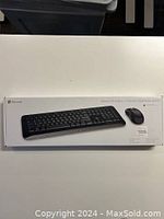 Microsoft Wireless 850 Desktop keyboard and mouse boxed retail packaging on a white table, full set visible.