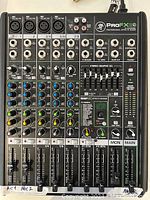 Top-down view of ProFX8 v2 mixer showing all eight input channels, faders, knobs, EQ sliders and main output section