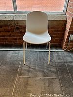 Single chair front view showing seat shape and leg design