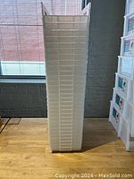 Side stacked view of clear rectangular plastic storage bins showing uniform shape and size.