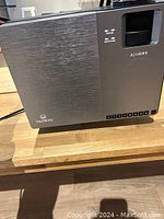 Silver Yankyo projector showing front panel with focus and keystone controls and branding