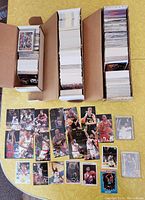 Three boxes packed with hundreds of basketball cards from Fleer early 1990s sets and NBA Hoops 1990