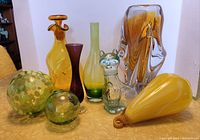 Front view of all eight glass pieces arranged side by side