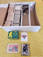 White box with four rows of packed hockey cards, mostly 1990-1991 Pro Set, plus two special card inserts and a Score Rookie Rated box