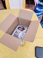 Card lot in cardboard box, cards in sleeves
