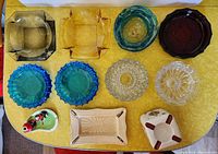 Overhead view of all 11 ashtrays and decorative dishes showing a variety of shapes and colors