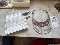 Lot overview showing bib necklace, earrings, clasp components and paperwork
