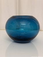 Front view of the vivid blue bubble glass vase showing its round shape and textured bubbles inside the glass.