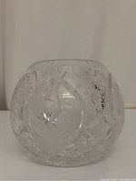 Side view of the crystal bowl showing diamond and sunburst cut patterns with floral etched panel.