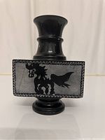 Front view of the black marble vase showing horse and floral design in enamel.