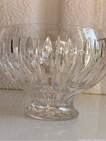 Side view of clear crystal Marquis Waterford bowl showing vertical oval cuts and faceted pedestal base.