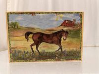 Top-down view of the hand-painted horse on the lid, showing countryside details and decorative borders