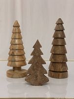 Three hand-turned wooden mini trees grouped together showing size difference and design variations.