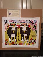 Overall view of the lithograph mounted on cardboard with descriptive placard above.