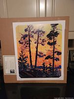 Full view of the lithograph with sunset pine tree scene on cardboard backing showing accompanying descriptive card.