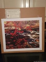 Photo of the lithograph print with its Certificate of Authenticity visible above it, showing the full image and some of the surrounding border material.