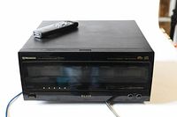 Black Pioneer PD F109 CD player with remote on top, front view showing controls and headphone jacks.