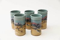 Five pottery water glasses standing with artistic landscape design and earth tone colors.