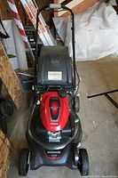 Front view of Honda HRN216 gas lawn mower showing deck and handle