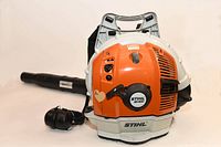 Front view of Stihl BR 600 backpack blower with ear protection muffs on table.