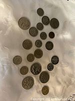 Overhead view showing all 18 Australian coins of varied denominations arranged on fabric.