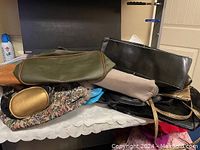 View of stacked purses showing different styles and colors