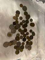 Collection of Hong Kong coins laid out on a white tablecloth, showing many different sizes and designs.