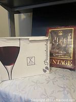 Two original Pasabahce wine glass boxes, one with a large wine glass image and one with a vintage collection label.