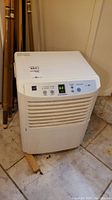 Front view of white Zenith ZD300Y0 dehumidifier with digital control panel and vented front.