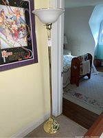 Full view of the metal base floor lamp showing its height and base in a room corner.