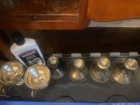 Five sterling silver weighted candlesticks laid upside down showing bases and included silver polish bottle