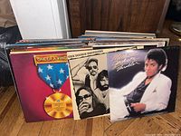 Front view of three vinyl albums: Steely Dan – One of a Kind; The Doobie Brothers – Minute by Minute; Michael Jackson – Thriller.