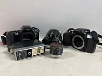 Lot group showing Canon EOS Rebel X S camera body, Pentax PZ-10 camera body, Sears 006 flash, Nikkorex zoom lens, Pengrowth binoculars