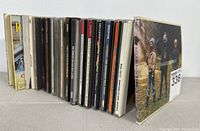 Stack of 20 music CDs showing spines with various artists and titles.