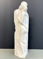 Full side view of chalk ware figurine showing a standing woman leaning on textured background, white matte finish, approximately 15 inches high.