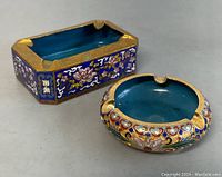 Photo showing both brass cloisonné enamel ashtrays, highlighting colors and shape