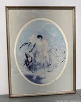 Framed lithograph showing two women in gowns with birds, in oval format.