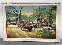 Full view of the framed painting showing rural scene with water buffalo cart and woman figure.