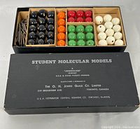 Full contents of the molecular model kit including spheres and connecting rods in original box with lid showing brand and product information.