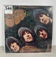 Front cover of The Beatles Rubber Soul vinyl record showing album title and portraits of band members.