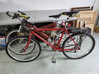Two bikes side by side showing copper Gary Fisher frame in front and red Rocky Mountain frame behind