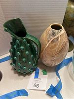 Photo showing both vases together, the green handmade Italian ceramic vase with teardrop details and the marble-look ceramic vase side by side.